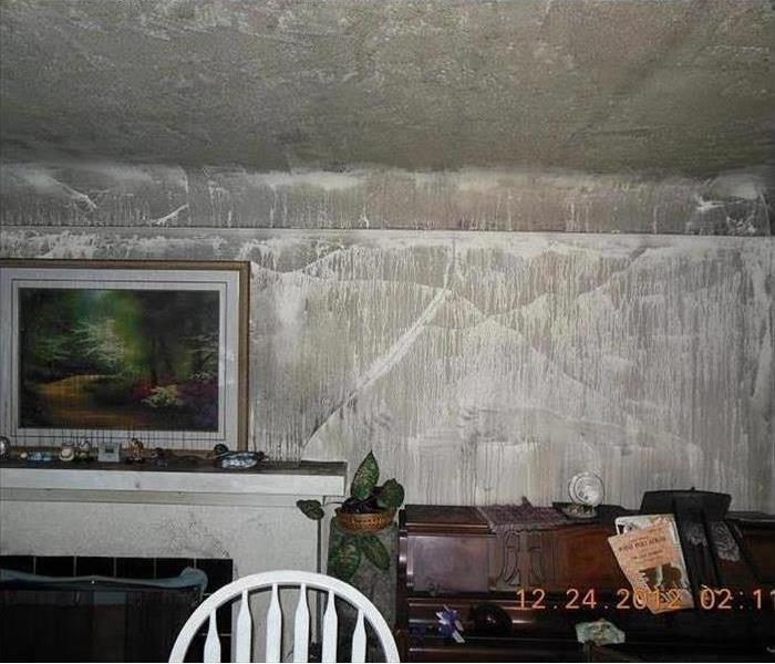 Fire and smoke damage to wall and piano