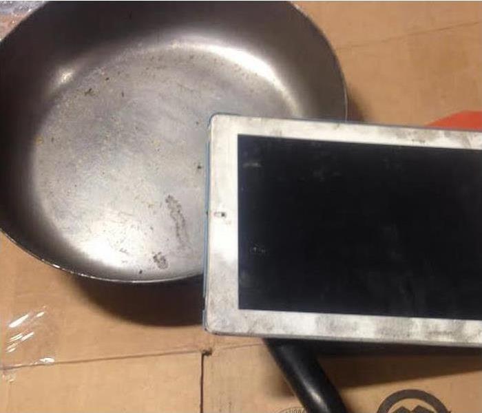 Smoke and soot damage on household items, cooking utensils, iPad