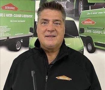 Man With Black Coat In Front Of Green Truck Poster