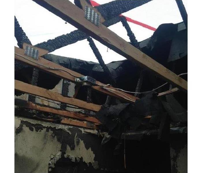 Fire damaged ceiling and roof open to the sky