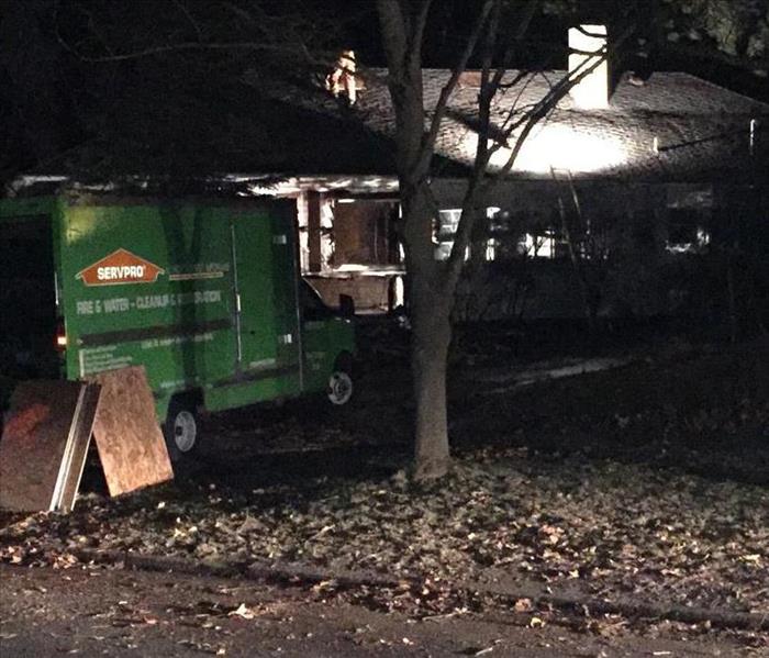 SERVPRO team boarding up home at night