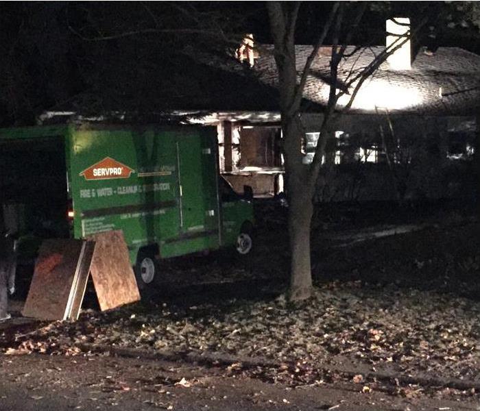 SERVPRO team boarding up home at night