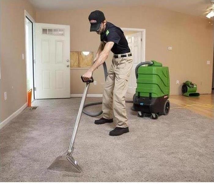 Guy cleaning carpet with machine  